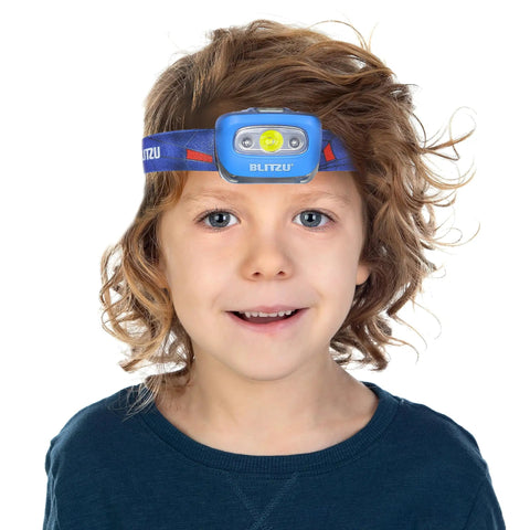 Child wearing hands free headlamp with adjustable lighting modes, 165 lumen, battery powered, waterproof and impact resistant