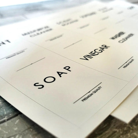 Close-up of waterproof laundry room labels for containers and cabinets featuring modern cleaning labels for easy organization.
