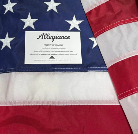 Close-up of Made In USA Outdoor 3x5 American Flag with Premium 200D Nylon Embroidered Stars, hand sewn stripes visible.