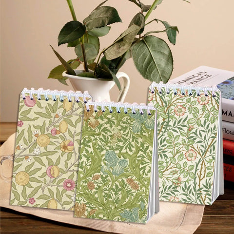Pocket-Sized Floral Notebooks Set with vintage botanical designs, mini spiral journals 2.36 x 3.94 inches displayed on a table