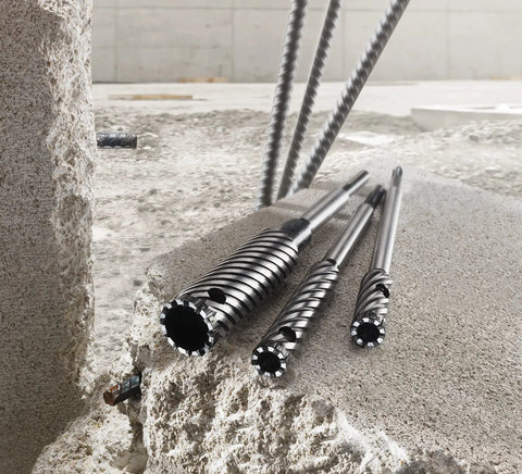 9/16 Inch by 12 Inch SDS-Plus Rebar Cutter Drill Bit With Steep Spiral Flutes, Carbide Tip, shown with concrete debris on site