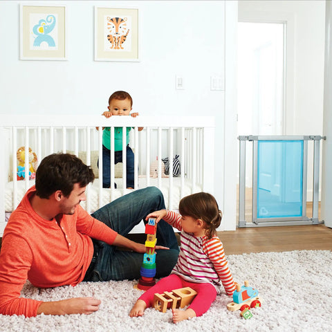 Living room with children playing and an adult, Vibe Mesh And Steel Baby Gate In Berry with Turnkey Mounts in background.