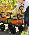 Woman loading corn and pumpkins into Heavy Duty Steel Dump Cart With 600 Lb Capacity Utility Wagon And Inflatable Ten Inch Tires
