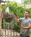 Man using Heavy Duty Swivel Connect Watering Wand Hose Sprayer With Five Spray Patterns for garden hanging basket