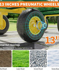 Close-up of 13-inch all terrain tires on heavy duty steel garden cart wagon with 1400 lb capacity and rotating swivel handle.