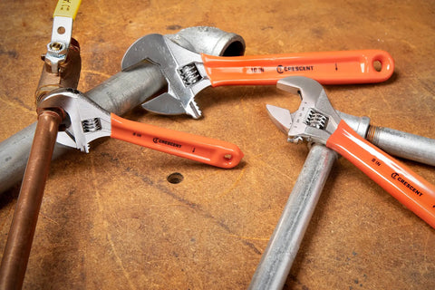 Three Piece Adjustable Cushion Grip Wrench Set With 6 Inch, 8 Inch And 10 Inch Jaw Wrenches on metal pipes