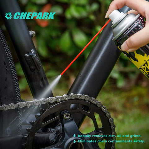 Drivetrain Cleaning And Lubrication Essentials Kit With Bicycle Degreaser And Lubricant Brush Tool spraying on bike chain
