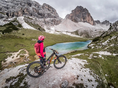 Cyclist with mountain bike equipped with Front Bike Fender For Face And Suspension Fork Protection overlooking alpine lake.
