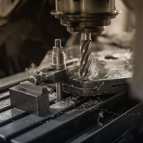 Close-up of annular cutter in a magnetic drill press cutting metal.