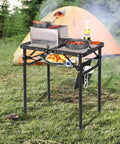 Foldable Grill Table For Outdoors, Lightweight Aluminum Frame, Height Adjustable From Low To Tall, Dense Mesh Desktop shown at campsite
