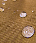 Close-up of water droplets on heavy duty waxed canvas, illustrating water resistance of Waxed Canvas Zipper Pouch Set.