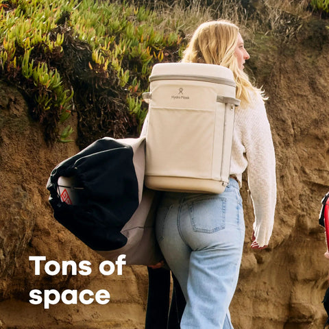 Carryout Cooler Backpack With All Day Cold Insulation And Portable Soft Build Trail And Park Friendly Features An Ergonomic Strap System 22 Liter Capacity In Shale Gray on a woman, carrying on a hike.