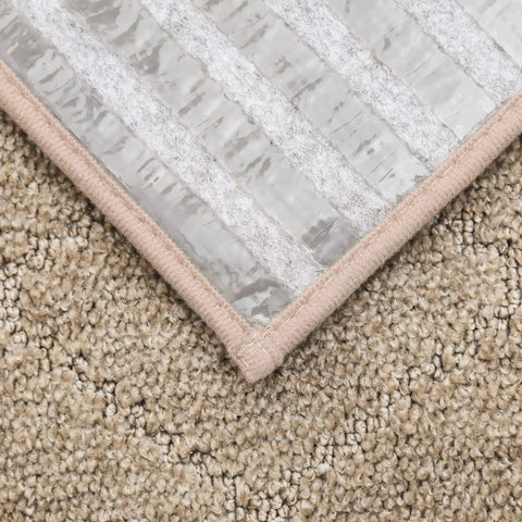 Close-up of beige Non Slip Stair Treads For Wood Steps 28x9 Inch Beige 15-Pack Indoor Runner Mats With TPE Backing on carpet