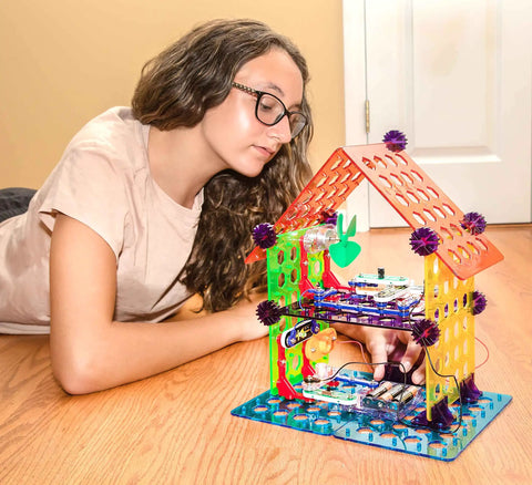 Child exploring Elenco My Home Electronics Building Kit For Kids Aged 8 And Up With 34 Hands On STEM Projects And Color Coded Blocks