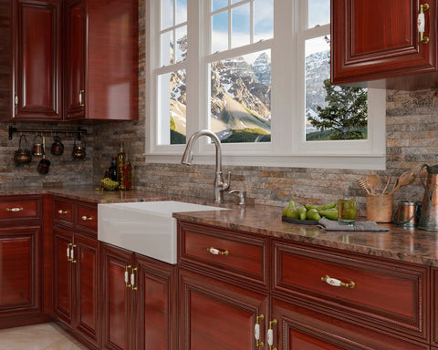 High Arc Kitchen Faucet With Pull Down Sprayer And Soap Dispenser, stainless finish, installed in kitchen with wooden cabinets.
