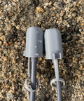 Grey Starlink Gen 3 Cable Silicone Caps protect gear from dust and water, on gravel, with snap fastening, V3 accessories.