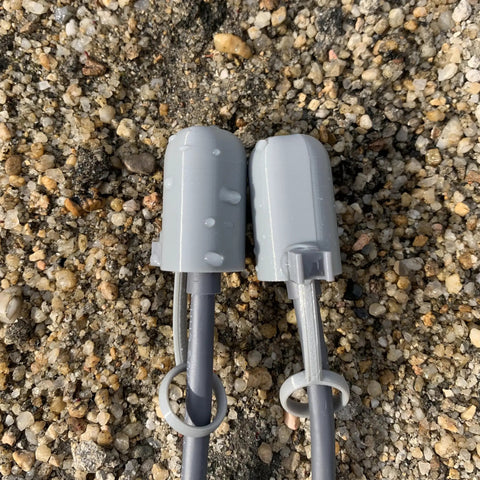 Grey Starlink Gen 3 Cable Silicone Caps protect gear from dust and water, on gravel, with snap fastening, V3 accessories.