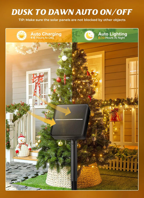 Solar panel on lawn with festive tree decorated with 2 Pack 400 LED 144 Foot Solar String Lights Outdoor IP65 Waterproof.