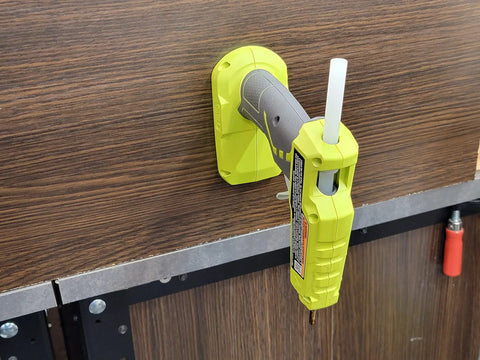 Glue gun mounted on wall using 18V Cordless Tool And Battery Mounts Set 12 Pack With Six Tool Mounts And Six Battery Brackets