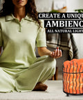 Person meditating near Pink Himalayan Salt Lamp With Dimmer Switch In A Tall Round Metal Basket, 8 To 10 Lbs