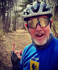 Man wearing Polarized Sports Sunglasses With Five Interchangeable Lenses For Guys And Gals, Ultralight 19.2g, on a forest trail.