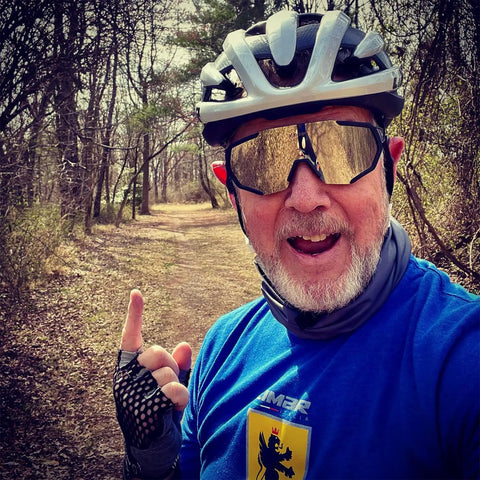 Man wearing Polarized Sports Sunglasses With Five Interchangeable Lenses For Guys And Gals, Ultralight 19.2g, on a forest trail.