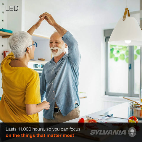 Elderly couple dancing in well-lit kitchen under LED Light Bulb 60W Equivalent A19 Four Pack, 8.5W Efficient Daylight Frosted 800 Lumens