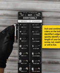 Person holding Identibolt Precise Threadchecker And Wall Mount Kit For Imperial SAE And Metric Threads against brick wall.