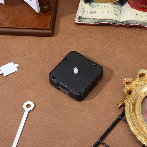 WhisperSilent Quartz Wall Clock Movement Kit With 8mm No Thread Shaft on a table, showcasing its silent mechanism for DIY projects.