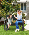 Woman and child sitting on Outdoor Glider Bench With Steel Frame 2 Seat Porch Loveseat Swing For Patio Garden And Backyard Rocking Chair For Porch And Lawn In Dark Green Smooth Quiet Glide And Cozy Outdoor Relaxation in a backyard