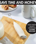 Powerful Handheld Milk Frother For Lattes And Cappuccinos Battery Powered Mini Drink Mixer Perfect For Home Barista Use Creamy Foam In Seconds Great For Matcha And More displayed on wooden board with coffee items.