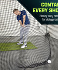 Person using 10 Foot By 10 Foot Sports Netting Hitting Net for indoor golf practice. Heavy-duty mesh contains shots in training space.