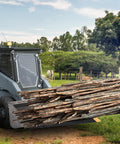 Clamp On Pallet Forks For Tractors And Skid Steers 43 Inch Long 2000 Lb Capacity carrying wood on skid steer at farm