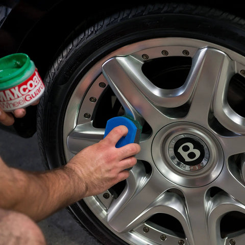 Applying Wheel Guard Max Coat Rim Sealant 8 Oz Dope Shine Ultra Durable Wheel Coating on a silver car wheel.