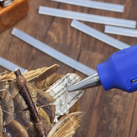 Using Hot Glue Gun Sticks Pack 60 Count Mini 4 Inch Sticks For DIY Projects Clear Dual Temp Non Toxic Works On Wood Metal Glass Cardboard Paper And More Ideal For Crafting And School Projects on a wooden craft.