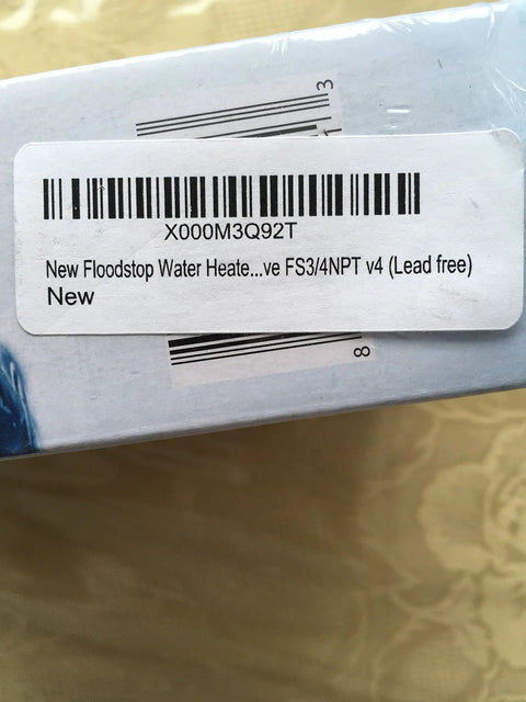 Box label showing 'New Floodstop Water Heater Valve' with barcode and FS3/4NPT v4 lead free, placed on light surface.