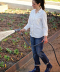 Person watering garden with Flexogen 5/8 Inch X 50 Ft Garden Hose Heavy Duty Water Hose Built To Last, Flexible And Kink Resistant