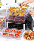 No Stress Food Dehydrator With Eight Stainless Steel Trays, drying fruits, digital timer, and heat settings visible on counter.