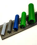 Color-coded silicone plugs from the 350 Piece Pro Grade High Temp Silicone Plug and Cap Kit for Powder Coating on a ruler.