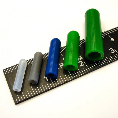 Color-coded silicone plugs from the 350 Piece Pro Grade High Temp Silicone Plug and Cap Kit for Powder Coating on a ruler.