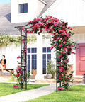Garden Arch Trellis With Extended Top 7.5Ft Black PE Coated Steel Arbor For Climbing Plants And Vines in a garden setting