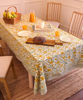 Top Tier Floral Block Print Cotton Tablecloth Yellow Rectangular Dining Cover Washable Farmhouse Kitchen Linen on a dining table.