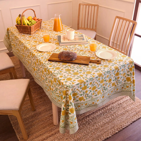 Top Tier Floral Block Print Cotton Tablecloth Yellow Rectangular Dining Cover Washable Farmhouse Kitchen Linen on a dining table.
