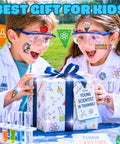 Kids with science-themed temporary tattoos excitedly opening gift, wearing lab coats and glasses. Outdoor science-themed party.
