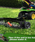 40-Inch Tow Behind Spike Aerator With Galvanized Steel Tines attached to tractor on lawn