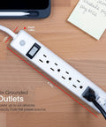4 Pack 6 Outlet Power Strip With 12 Ft Extension Cord on desk, closeup of grounded outlets with heavy duty flat plug, white