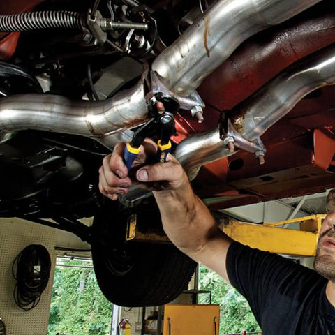 Mechanic using V Jaw 10 Inch Vise Grip Pliers With Press And Slide Button for Two Times Faster Jaw Adjustment on car exhaust pipe.