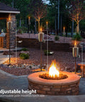 Stainless Steel Outdoor Torches Set Of 2 5 Ft Citronella Oil Lamps with varying heights around a backyard fire pit