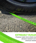 Flexible One Quarter Inch 100 Foot Reinforced PU Air Hose With Fittings And Plug Kit shown under tire, abrasion-resistant.