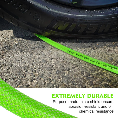 Flexible One Quarter Inch 100 Foot Reinforced PU Air Hose With Fittings And Plug Kit shown under tire, abrasion-resistant.